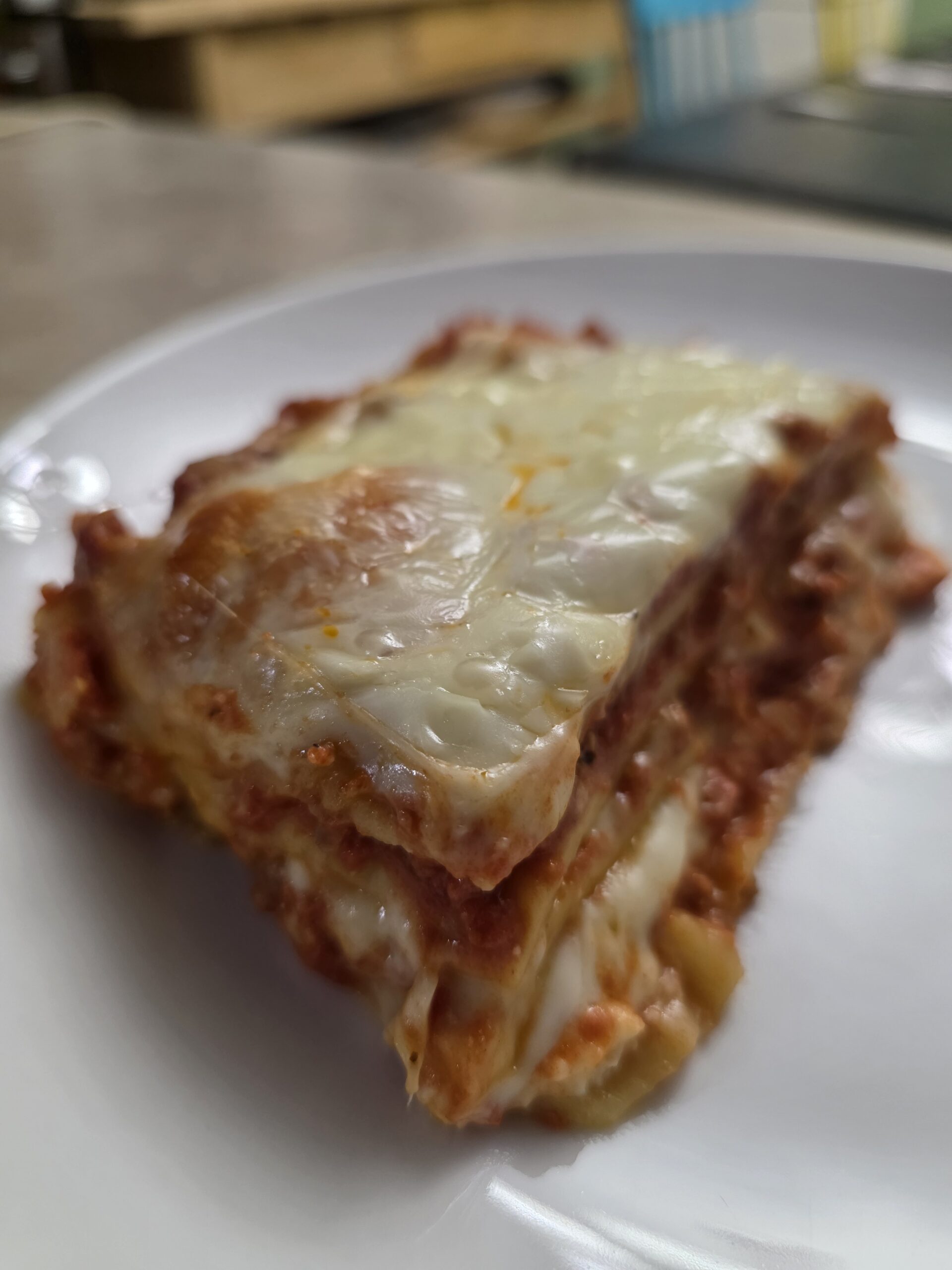 slice of gluten-free lasagna on a white plate