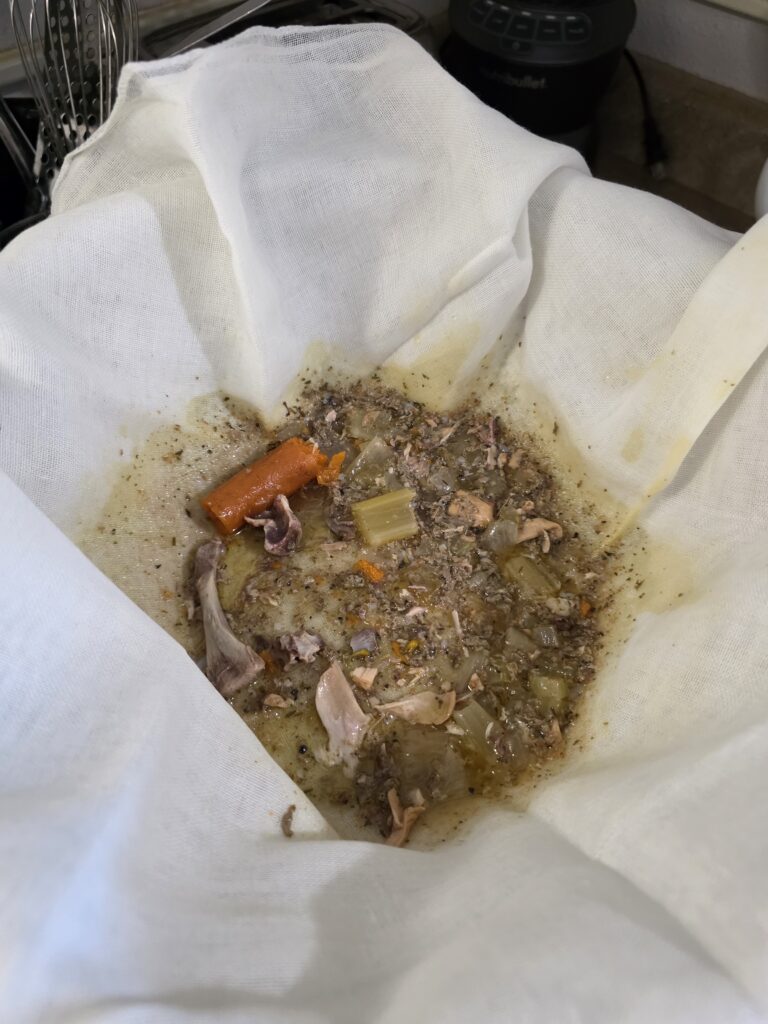 cheese cloth showing discard from first straining of chicken broth