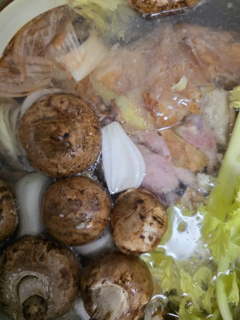 chicken broth veggies and chicken bones ready to cook