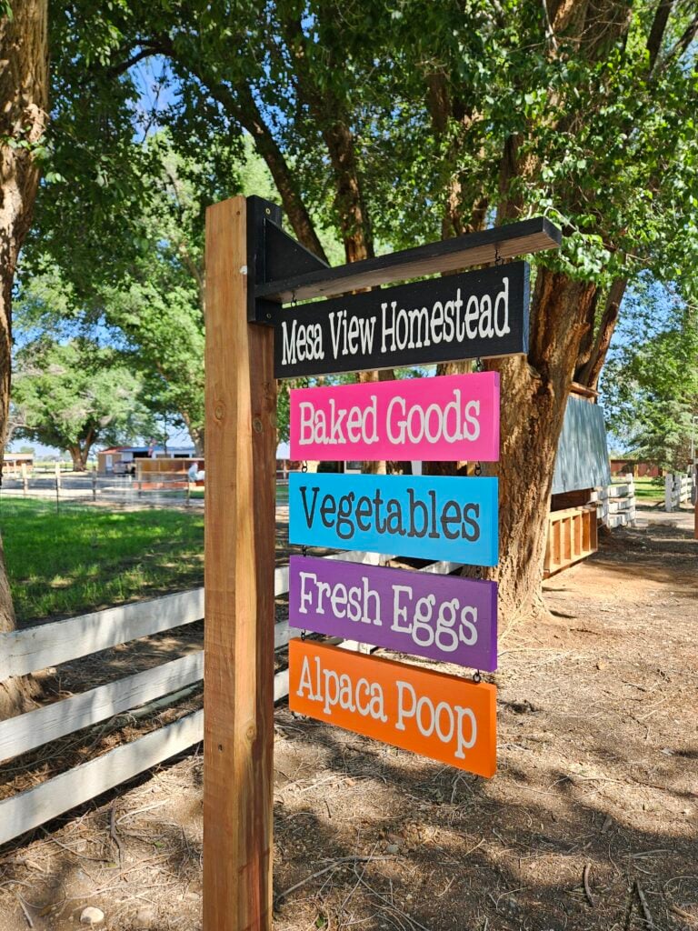 farmstand sign for Mesa View Homestead: baked goods, vegetables, fresh eggs, alpaca poop