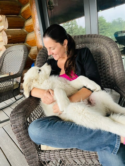 Cassie Monblatt, Colorado Mountain Dog breeder with one of her puppies